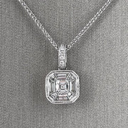 An 18 karat white gold pendant with mixed cut diamonds at the centerpiece.