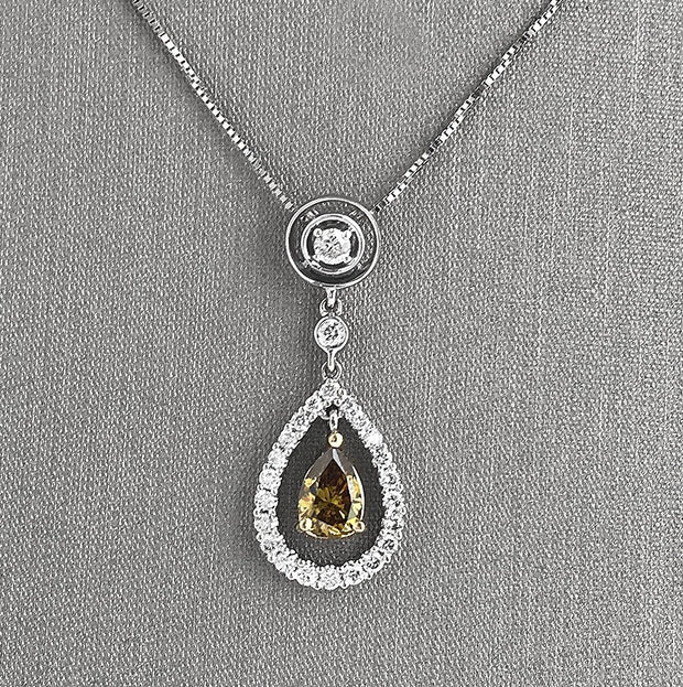 Green pear-shaped diamond with diamond halo drop pendant necklace.