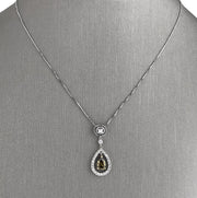 Green pear-shaped diamond centerpiecem with round brilliant cut diamond accents.