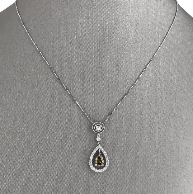 Green pear-shaped diamond centerpiecem with round brilliant cut diamond accents.