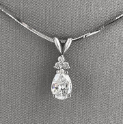 Beautiful pear-shaped diamond with atrio of round diamond accents.