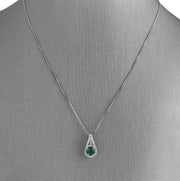 Emerald and diamond halo pendant.