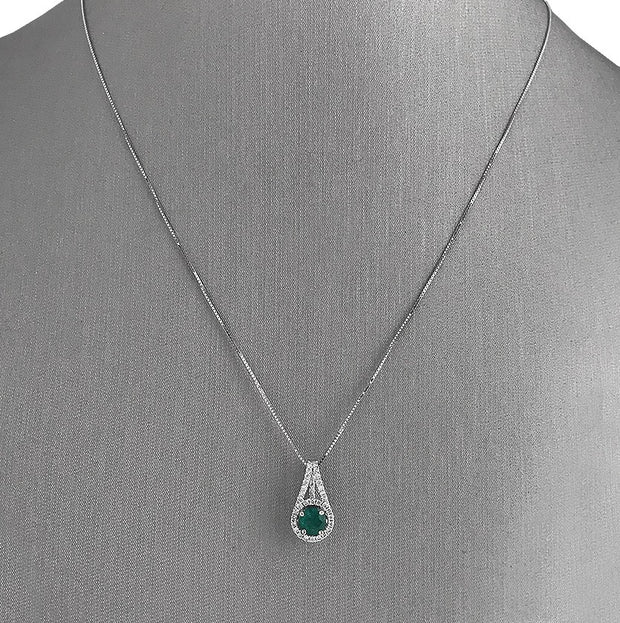 Emerald and diamond halo pendant.