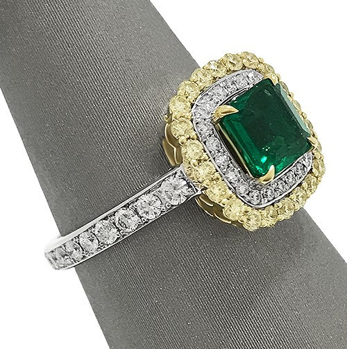 1.00 carat emerald with rich, vivid color
0.81 carats total weight of white and yellow diamonds in a double halo.