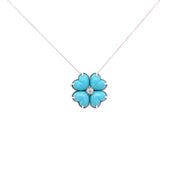 Four-leaf clover necklace featuring turquoise cabochons and round diamond in white gold