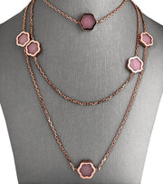 An 18 karat rose gold long necklace with nine pink opal motifs.