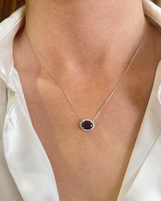 Model wearing 1.86 carat sapphire pendant with 0.09 carat diamond halo set in 18K white gold, showcasing elegant and timeless fine jewelry