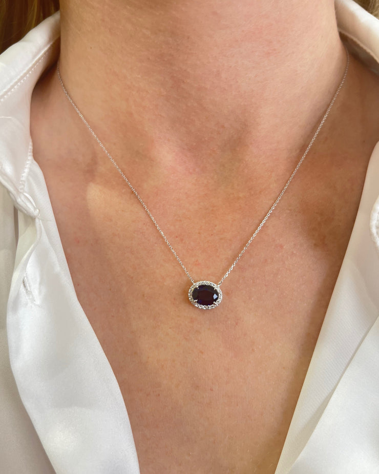 Model wearing 1.86 carat sapphire pendant with 0.09 carat diamond halo set in 18K white gold, showcasing elegant and timeless fine jewelry