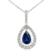 A pear-shaped sapphire pendant with a diamond halo set in 18k white gold, suspended from a fine gold chain.