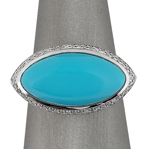 An 18K white gold diamond and Sleeping Beauty turquoise ring with a marquise shape and a round brilliant cut diamond accent.