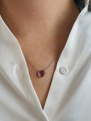  At its center lies a 1.41 carat pink sapphire slice, showcasing a vivid hue and natural, freeform shape that speaks to the raw beauty of the gem.