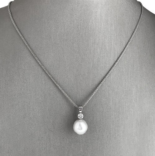 Beautifully balanced diamond and pearl pendant necklace.