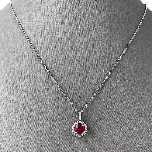 Vivid and romantic, this ruby and diamond halo pendant is a celebration of passion and timeless elegance.