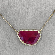 Diamond halo ruby necklace.