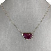 An organic ruby slice centerpeice with diamond halo necklace.