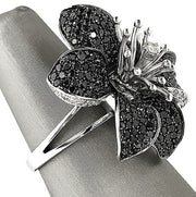 Pavé set black diamond petals with white diamond center for high contrast brilliance.