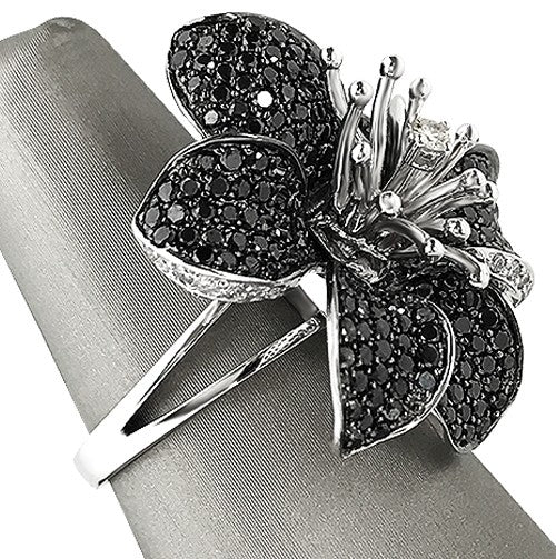 Pavé set black diamond petals with white diamond center for high contrast brilliance.
