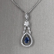 A detailed view of the sapphire and diamond pendant necklace.