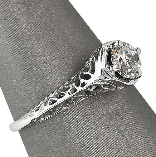 Profile view showing the diamond’s crown and the airy silhouette of the setting.