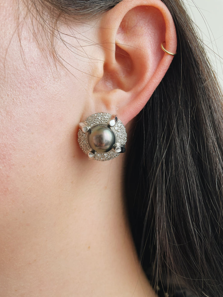 Close-up of luxurious white gold earrings featuring South Sea pearls and diamonds

