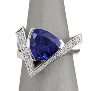 Trillion-cut Tanzanite ring set in 18K white gold with pave-set diamond accents in a V-shaped design